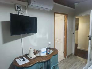a room with a flat screen tv on a wall at Swallows Nest in Laingsburg