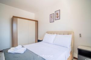 a bedroom with a bed with white sheets at 1-Bedroom Apt in Floripa OAN0305 in Florianópolis +16 photos