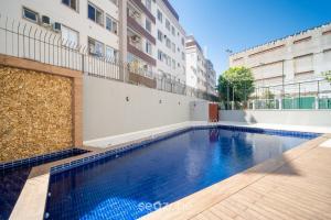 a swimming pool in front of a building at 1-Bedroom Apt in Floripa OAN0305 in Florianópolis