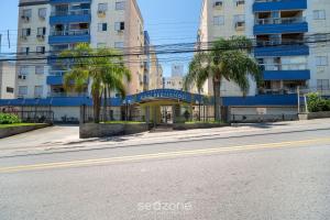 an empty street in front of a building with palm trees at 1-Bedroom Apt in Floripa OAN0305 in Florianópolis