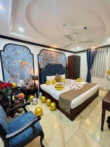 a bedroom with a large bed and a chair at Nam Cường X Hotel in Hanoi