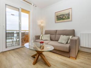 a living room with a couch and a glass table at Apartment Platja Mar by Interhome in L'Escala