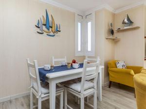 a dining room with a white table and chairs at Apartment Xaloc by Interhome in Cubelles