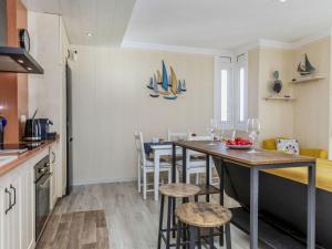 a kitchen and dining room with a table and chairs at Apartment Xaloc by Interhome in Cubelles +18 photos