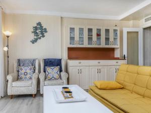 a living room with a couch and two chairs at Apartment Xaloc by Interhome in Cubelles