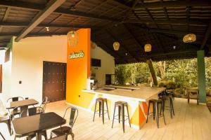 a patio with a bar with chairs and tables at Hotel de Campo Villa de Ada in Gracias