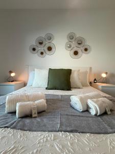 a bedroom with a large bed with two mirrors on the wall at John Shelter in Portimão +11 photos