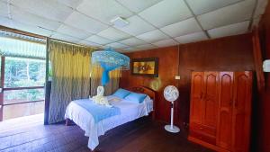 a bedroom with a bed with a stuffed animal on it at Jacamar Lodge Expeditions in Iquitos