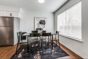 a dining room with a table and chairs and a refrigerator at Maison Noir Retreat 3B 2B KING in Richardson +6 photos