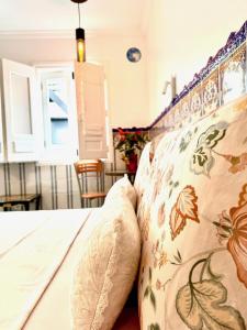 a bedroom with a bed with two pillows on it at Zenit Olhao baixa one bedroom house sea side view in Olhão