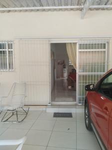 a red car parked in front of a garage at Bonito é ser Feliz Budget in Recife