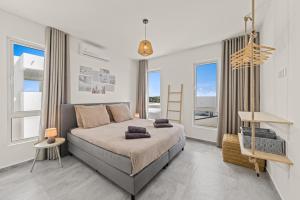 a bedroom with a bed and large windows at Cura Kaat - Ruime 4 slaapkamer villa met zwembad op gated resort in Jan Thiel +32 photos