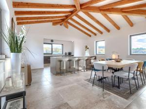 a kitchen and dining room with a table and chairs at Villa Maison Paradis by Interhome in Višnjan