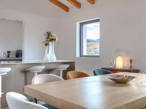 a dining room with a wooden table and chairs at Villa Maison Paradis by Interhome in Višnjan +22 photos