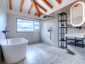 a bathroom with a large tub and a sink at Villa Maison Paradis by Interhome in Višnjan