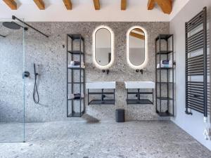 a bathroom with two sinks and two mirrors at Villa Maison Paradis by Interhome in Višnjan