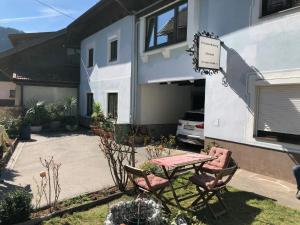 a patio with a table and chairs in front of a house at Ferienwohnung Walker in Oberdrauburg