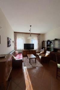 a large living room with couches and a tv at Ciasa Caligher in Venas