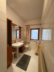 a bathroom with a sink and a toilet at Ciasa Caligher in Venas +22 photos