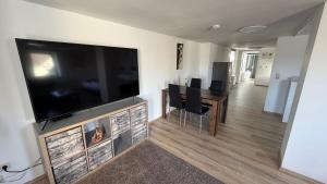 a living room with a large flat screen tv on a wall at Wohlfühlen am Großen Goitzschesee in Holzweißig