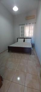 a bedroom with a bed and a tile floor at Skalia Mountain Sea Serenity in Kalymnos