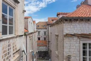 an alley in an old town with buildings at Dubrovnik Deluxe Rooms in Dubrovnik