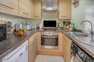 a kitchen with a sink and a stove top oven at 1 Bed in Errol oc-s33022 in Errol