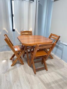 a wooden table and two chairs sitting next to each other at Small home in Ban Khlong Hok Wa
