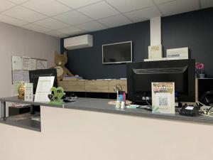 an office with a desk with a computer on it at ZEcamping 3 étoiles dog friendly avec piscine couverte et chauffée in Monclar-de-Quercy +27 photos