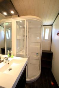 a bathroom with a white sink and a shower at ZEcamping 3 étoiles dog friendly avec piscine couverte et chauffée in Monclar-de-Quercy