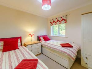 two beds in a bedroom with red and white at 3 Bed in Keswick oc-90266 in Applethwaite