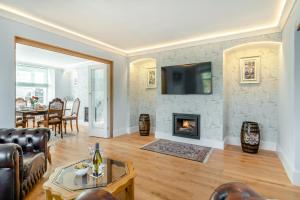 a living room with a couch and a fireplace at 3 Bed in Minehead oc-r30941 in Minehead