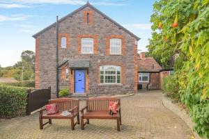 two benches in front of a brick house at 3 Bed in Minehead oc-r30941 in Minehead