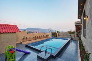 a swimming pool on the side of a building at Breeze Resort Panhala , Swimming Pool, Just 5 Minutes From Panhala! in Panhāla