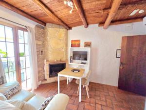 a living room with a table and a fireplace at jade in Ubrique