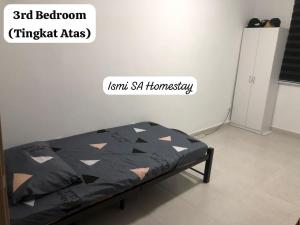 a bed in a room with a sign on the wall at Ismi SA Homestay in Rawang