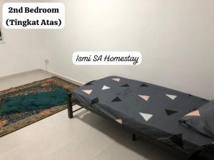 a bedroom with a bed in the corner of a room at Ismi SA Homestay in Rawang