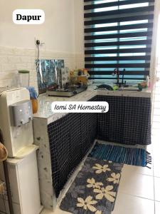 a kitchen with a sink and a counter top at Ismi SA Homestay in Rawang