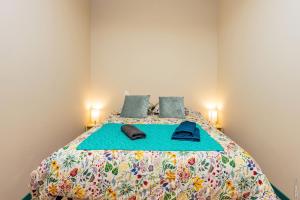 a bedroom with a large bed with a colorful bedspread at Le Figuier - Studio de Charme in Lavaur