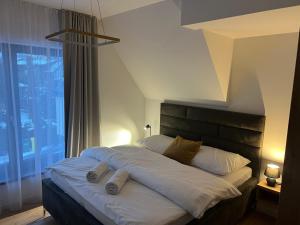 a bed with two pillows on it in a bedroom at JAMY HOUSE Apartmán in Habovka