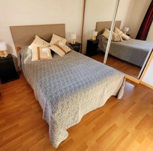 a bedroom with a bed and a mirror at Palmeras del sur in Mar del Plata
