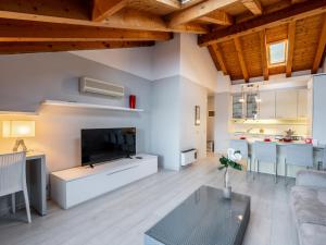 a living room with a large television and a table at Apartment Blu Lake by Interhome in Ghiffa