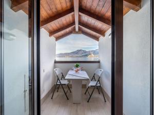 a table and chairs on the balcony of a house at Apartment Blu Lake by Interhome in Ghiffa