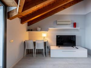 a living room with a table and a tv at Apartment Blu Lake by Interhome in Ghiffa +20 photos
