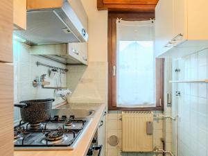 a kitchen with a stove top oven next to a window at Apartment Casa Silvia by Interhome in Carlazzo +20 photos