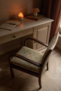 a chair sitting in front of a desk with a candle at Dimora Tre Galline in Canale