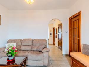 a living room with a couch and a table at Apartment Lakeview Menaggio by Interhome in Menaggio +37 photos