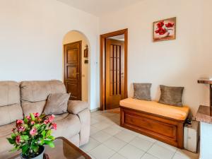 a living room with a couch and a chair at Apartment Lakeview Menaggio by Interhome in Menaggio