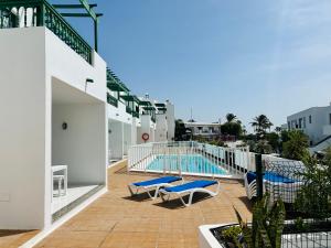 a swimming pool on the side of a building at -MONTORIAN View LANZAROTE- in Puerto del Carmen