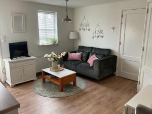 a living room with a couch and a table at B&B De Singel in Medemblik